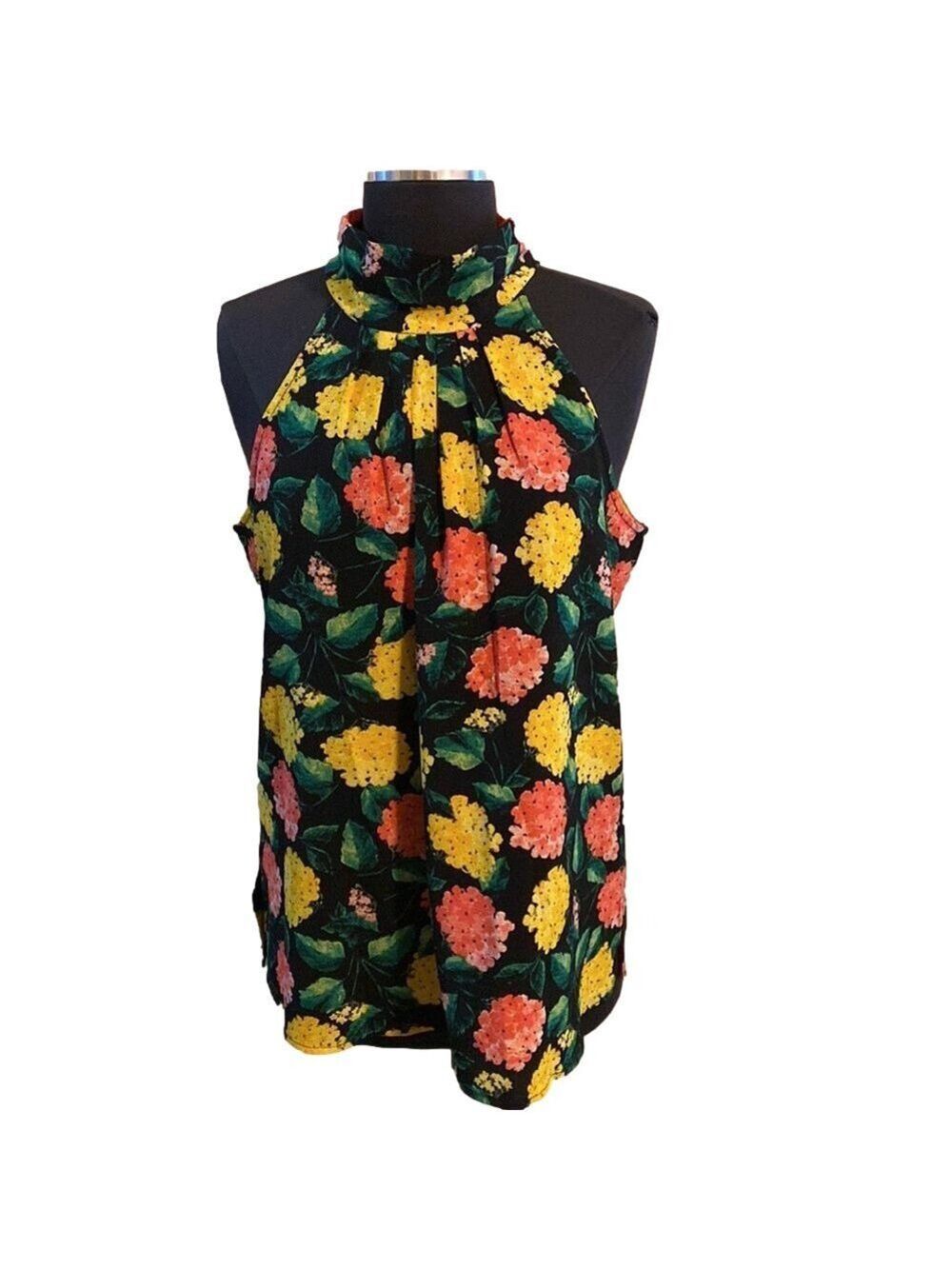 121.Yellow sleeveless patterned blouse with high neck and tie.